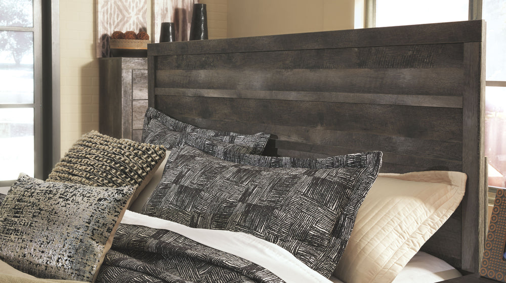 Rustic gray planked replicated oak grain with authentic touch. Large scaled dark colored hooded pull. Sticks across headboard give a thick planked look. Side roller glides for smooth operating drawers. Cases feature a framed front and pilasters. Large dra