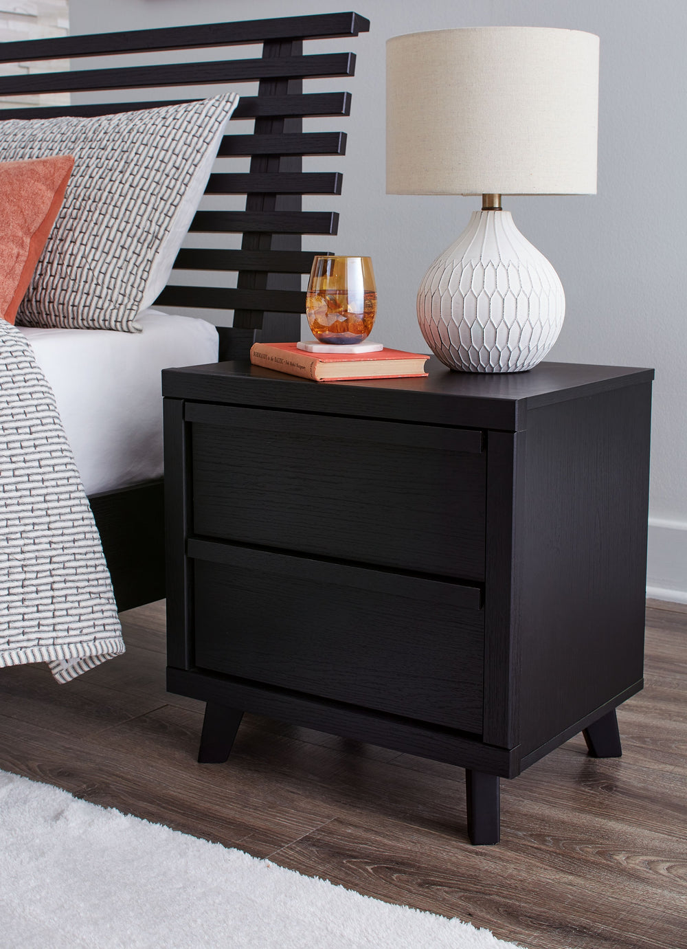 Sophisticated style for the savvy shopper. This nightstand prioritizes affordable, on-trend design. Its subtle replicated texture recalls the natural beauty of wood, highlighting the clean-lined form. And a matte black finish savvily suits different appro