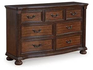 Take inspiration from the traditional luxury of this dresser. Classic with a rich cherry brown finish, its stately presence graces your room with an air of opulence. Your taste for exquisite details is satisfied with decorative drawer pulls and chic bun f