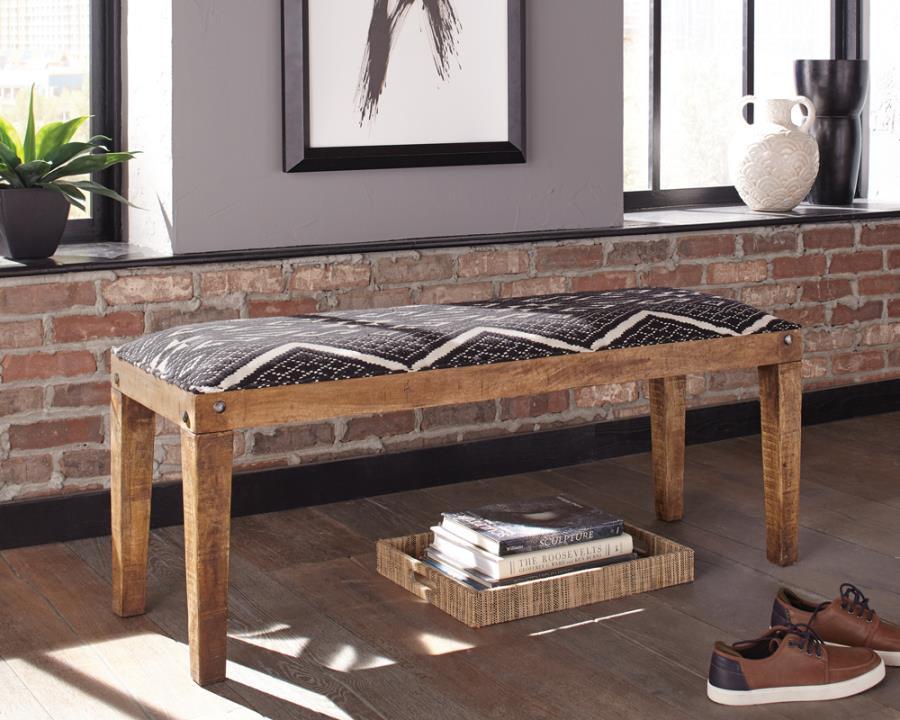 Elevate your space with this modern rustic bench, blending natural wood tones with bohemian-inspired upholstery. The solid mango wood frame showcases a rich, exposed grain, accented by decorative nailhead details for added charm. A bold black-and-white ge