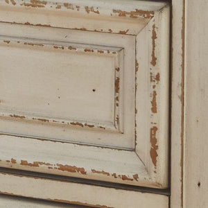  this dresser is your dream bedroom retreat realized. Its antiqued two-tone aesthetic blends a chipped white with a distressed wood finished top for added charm. Framed drawer fronts and decorative corbels 