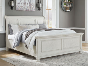  timeless furnishings take your bedroom to the next level. Nothing does that better than this king sleigh bed. The antiqued white finish with a wonderful grain texture radiates sophistication