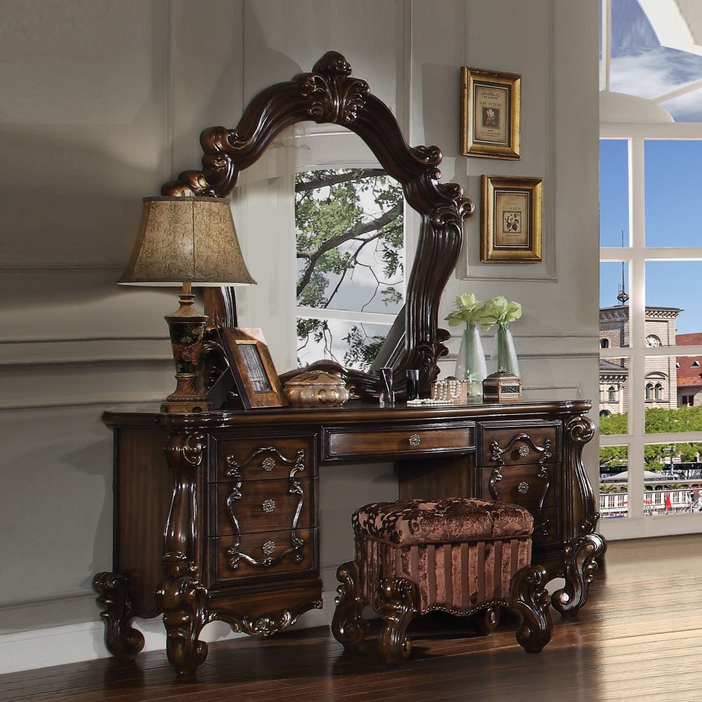 The Versailles vanity desk is the perfect accent to create the style of royalty your bedroom has been needing. This vanity desk crafted in wood with cherry oak finish was inspired by old European design with brown copper metal hardware and intricate wood 