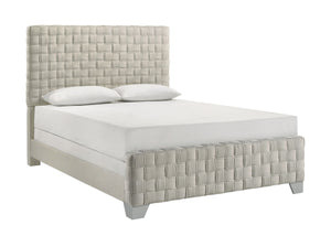 This bed is a statement piece that brings a touch of luxury and contemporary design to any bedroom setting. It features an oversized, padded headboard with a detailed basketweave pattern that adds texture and sophistication. The upholstery is crafted with