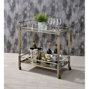 Add a touch of sophistication to your entertaining area with this Matiesen serving cart. With metal in antique brass finish, and clear tempered glass on the top shelf. The caster wheels allow you to move from room to room effortlessly. Simple and elegant,