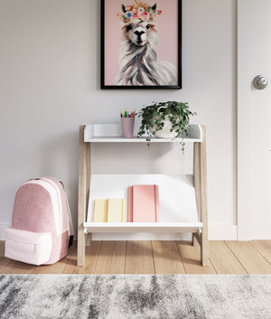  this stylish small bookcase provides the perfect place to prop their ever-expanding book collection. The unique angled lower shelf and gallery rail top in white charmingly contrast with the light tan frame