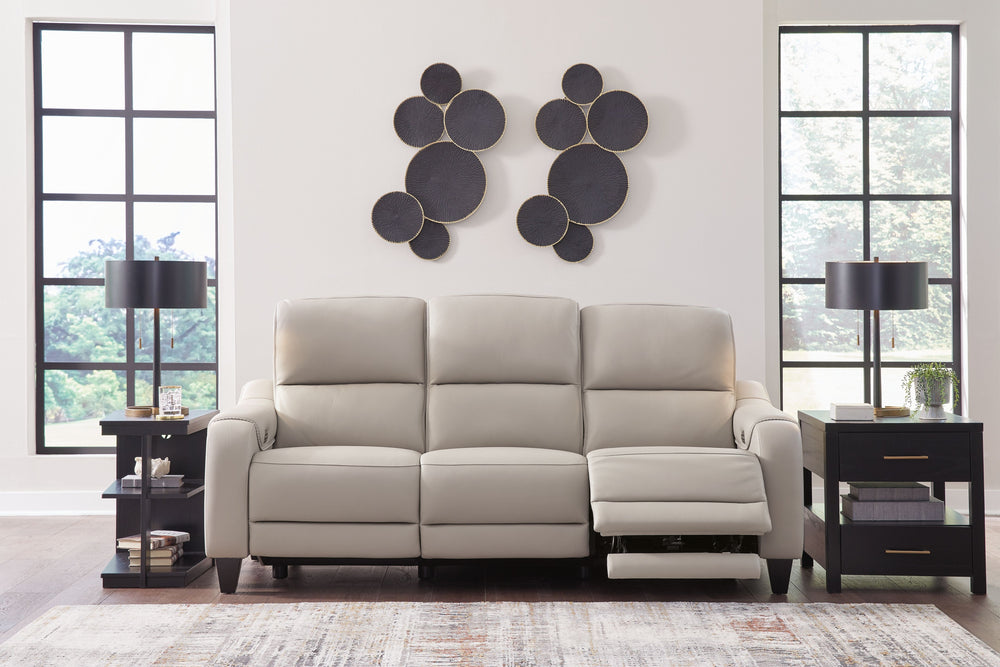 This power reclining sofa with matching loveseat puts a sleek twist on laid-back living. It satisfies your desire for comfort without being bulky in design, thanks to subtly incorporated one-touch reclining and adjustable headrests. With chic exposed legs