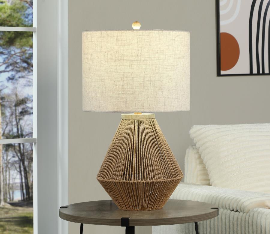 This lamp blends natural textures with modern design to create a stylish and versatile lighting solution. Featuring a woven rope base with a geometric silhouette, it adds a touch of organic charm to any space. The neutral fabric drum shade diffuses light 