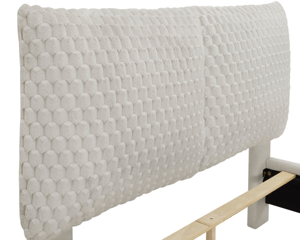  upholstered in a sumptuous fabric that invites a touch of elegance and comfort. The bed-