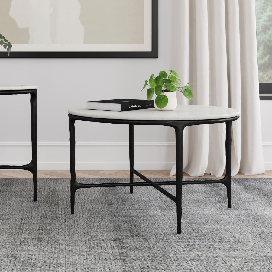 This coffee tableâ€™s genuine marble top rests on a sculptural metal frame, its subtly textured legs evoking artisanal craftsmanship. Present it as a center table, enhancing a refined lounge area. The marble surface makes an ideal backdrop for dÃ©cor, whi