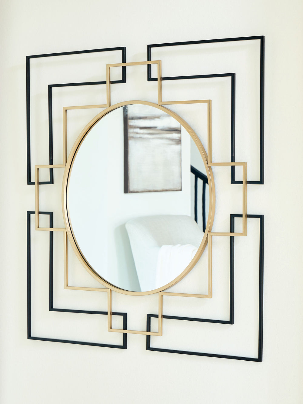 This accent mirror brings a layer of contemporary flair to traditional art deco motifs. Its frame, in a geometric design emphasized by black and goldtone finishes, makes a strong sculptural statement. What a sleekly stylish addition to a living room or en