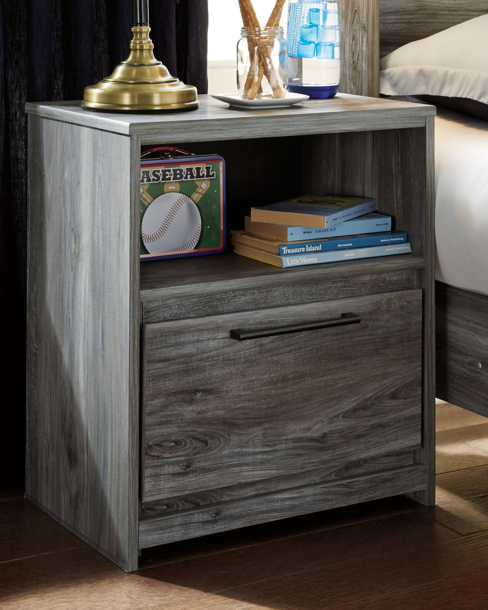 Beachy style and room for bedside essentials go hand in hand with this nightstand. Its driftwood and surfer-inspired smoky finish creates a rustic look that-'s perfect for setting the scene of an island getaway. Youâ€™ll find the drawer and cubby to be sp