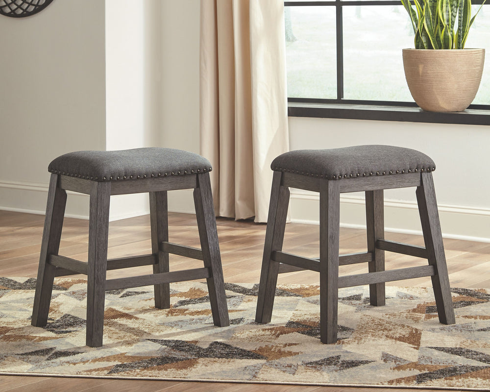 Bring a relaxed yet refined sense of good taste to a space with this upholstered stool. The clean-lined frame sports a gray-washed finish thatâ€™s so easy on the eyes. Covered in a complementary textured gray fabric, the stoolâ€™s cushioned upholstered se