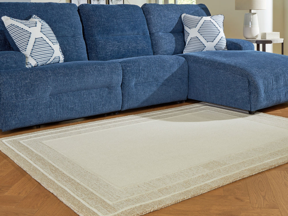 With its simple border design and soft, neutral color palette, this hand-tufted rug brings a touch of casual elegance to your abode. Its plush wool pile feels luxuriously soft underfootâ€”perfect for adding warmth and texture to your entertainment area, b