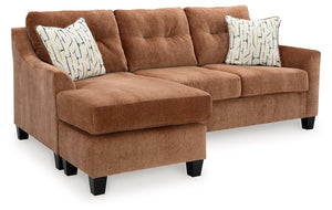 Urban contemporary meets mid century (with a pop of trend-right color) in this queen sofa chaise sleeper. Supremely soft upholstery, teeming with luster and movement, finesses the piece with just the right touch. Gently flared arms and tufted back cushion
