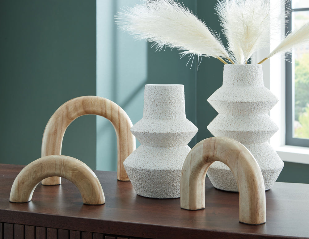 Craft a contemporary haven with the delightfully neutral tones and modern forms of this accessory set. Its sculptures, with their seamlessly streamlined arch designs, can be displayed together or stand solo as subtle statement pieces. The tiered look of t