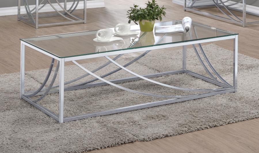 This rectangular coffee table boasts a modern design with a clear tempered glass top that highlights its sleek aesthetic. The sturdy metal frame, finished in electroplated polished chrome, features gracefully curved accents for an elegant touch. Its minim