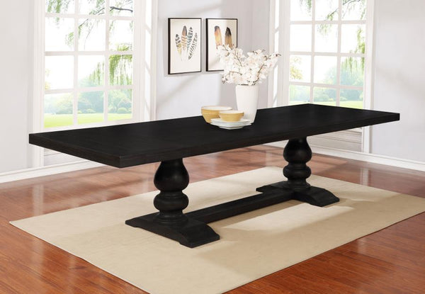  dramatic silhouette that adds an artful elegance to a formal space. This formal dining table offers a lush antique noir finish wood construction with a polished aesthetic. Its trestle-style base reflects sensual tapering and supports be