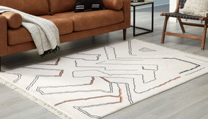  this accent rug features a modern abstract design that will warm your living space. Freeform lines with a knotted tassel edge elevate the look