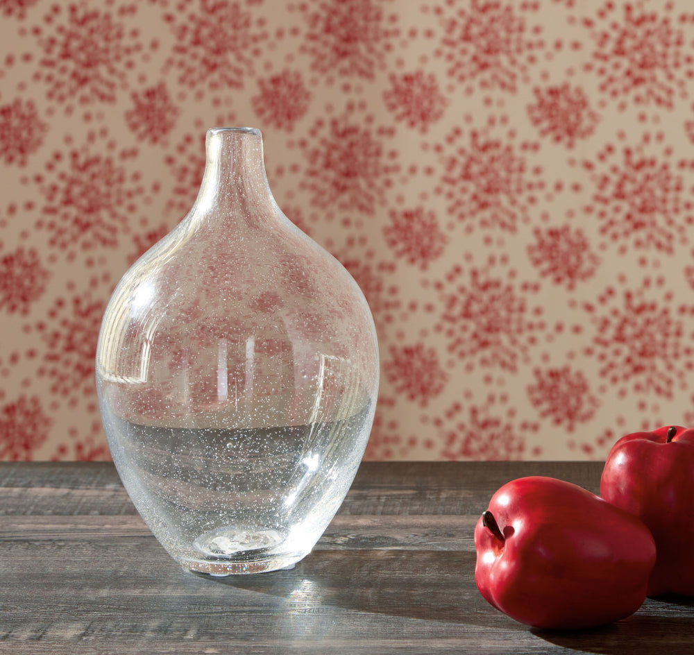 Infuse your shelf, mantel or tabletop with casual charm. Crafted from clear seeded glass, this vase effortlessly captures the essence of weathered beauty. Whether it-'s indoors or outdoors, this vessel is enchantingly simple unadorned or filled with your 