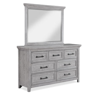 This bedroom suite offers a refreshing take on rustic charm, featuring a soft greige finish that highlights the natural wood grain. The sturdy bed stands as the centerpiece with its robust headboard and inviting design, while the accompanying pieces â€” a