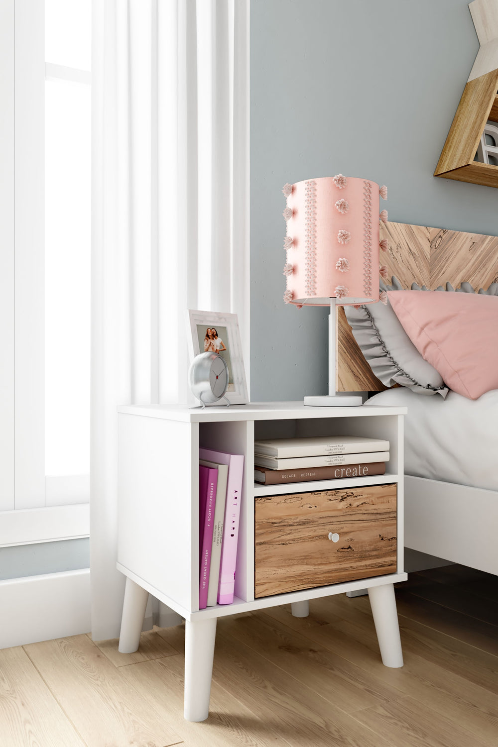 The perfect marriage of contemporary and casual style, this nightstand is a charming addition to your home. It-'s expressive with a two-tone look in a solid matte white finish and a replicated sugarberry wood grain pattern. White knobs and splay legs add 