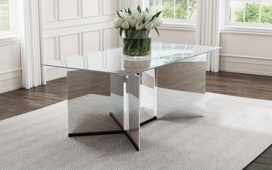 Make a statement in your glam dining room with a contemporary mirrored dining table. Its angular structure and rectangular tabletop are a dynamic collaboration, delivering dimension and depth in a refined space. Black trim complements V-shaped pedestals, 