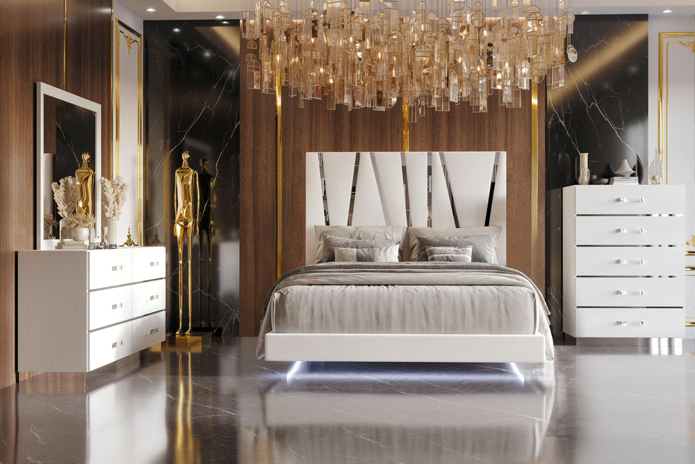 The Europa 4 Piece Bedroom Set in white offers a sophisticated and modern design for your bedroom. This set includes a panel bed along with a dresser, mirror, and chest. The sleek look is achieved with a majestic headboard, glossy white finish, acrylic dr