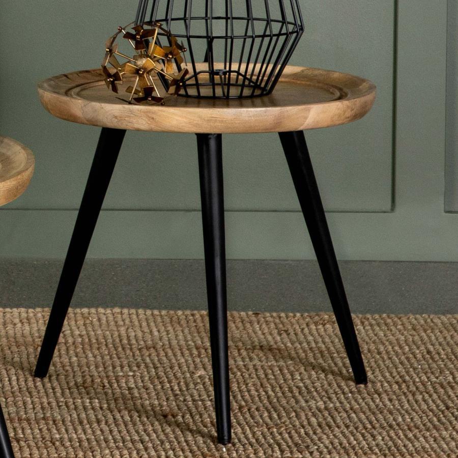 Infuse bohemian charm and mid-century style into your living space with this versatile end table. Crafted from solid mango wood, the round tabletop showcases natural wood grain patterns and a softly curved edge with carved detailing for added elegance. It