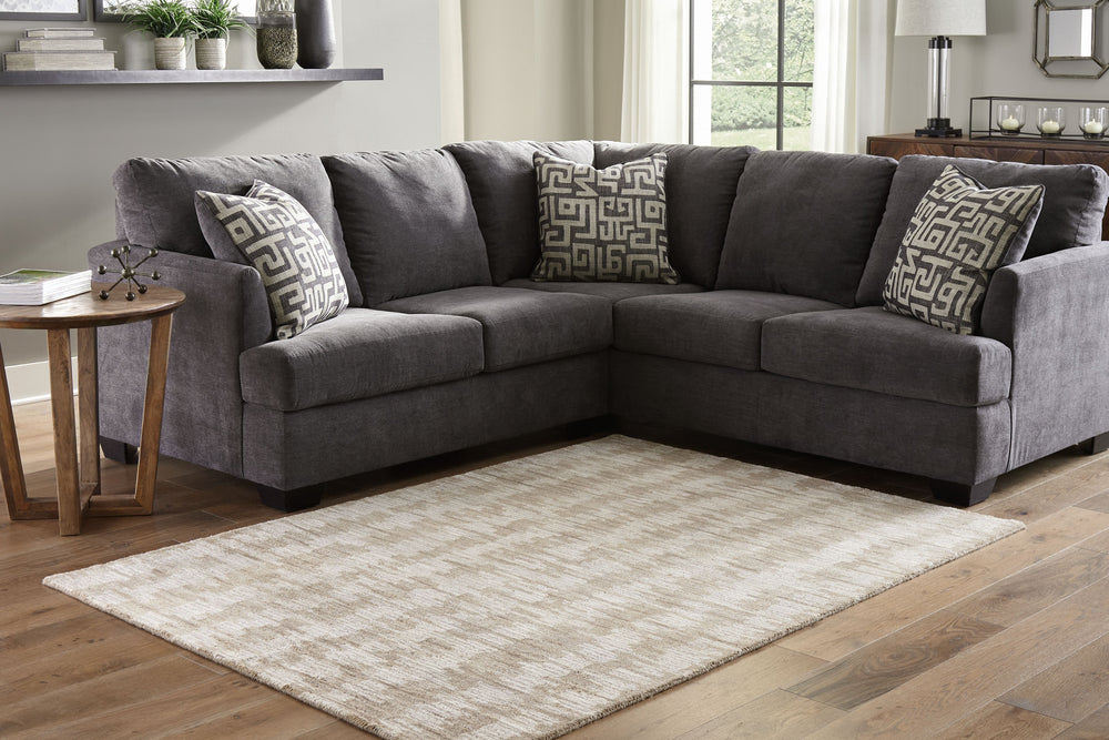 The hand-tufted modern design of this area rug will make a bold statement in any room. By alternating the pattern flow, the weavers have created a work of art alive with texture. Shades of cream and brown are blended to produce an abstract-yet-tranquil fe