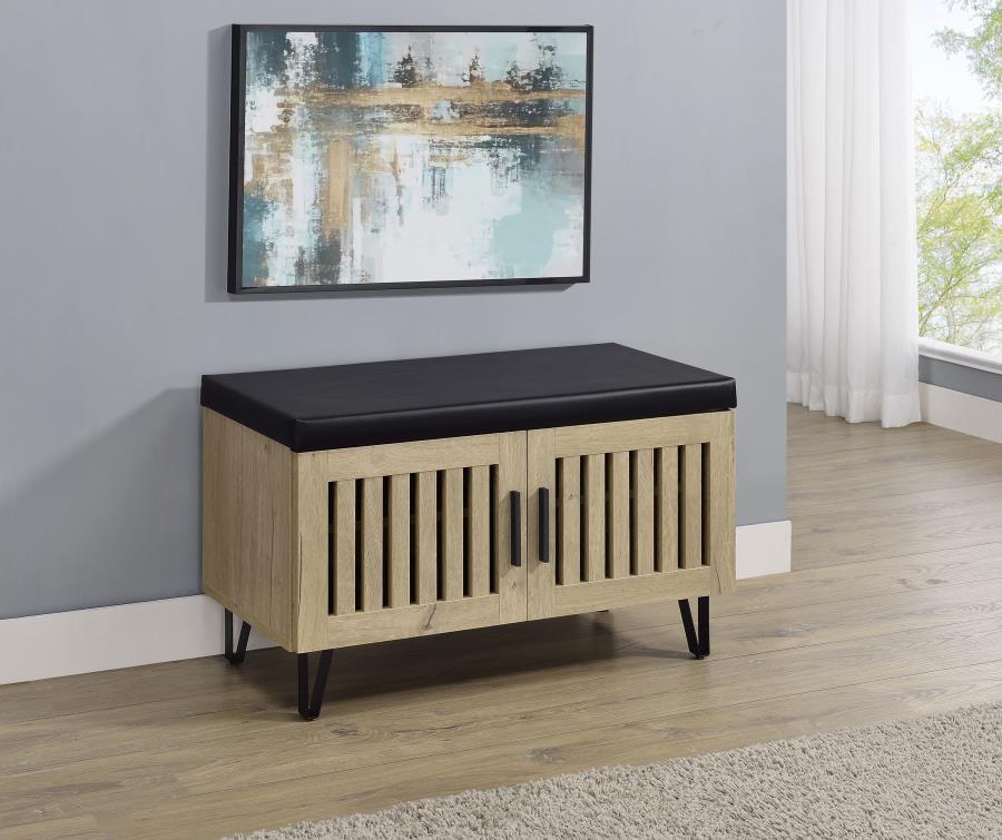 This modern storage bench combines style and functionality, featuring a faux leather upholstered padded top for added versatility as a seating bench. The cabinetâ€™s two doors showcase a vertical slat design, enhancing its contemporary aesthetic while all