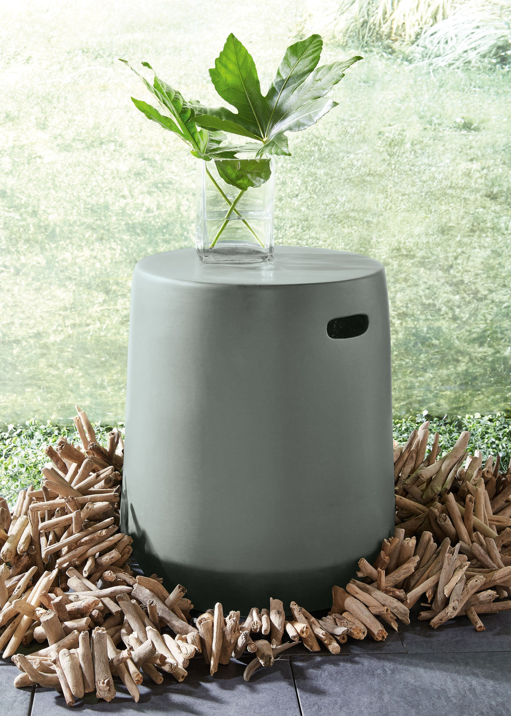 Add a pop of edgy elegance to an indoor or outdoor space with this masterfully minimalist ceramic stool. Its sleek design includes handholds on the sides for easier mobility. An inspired side table or plant perch, itâ€™s also outstanding all on its own.<b