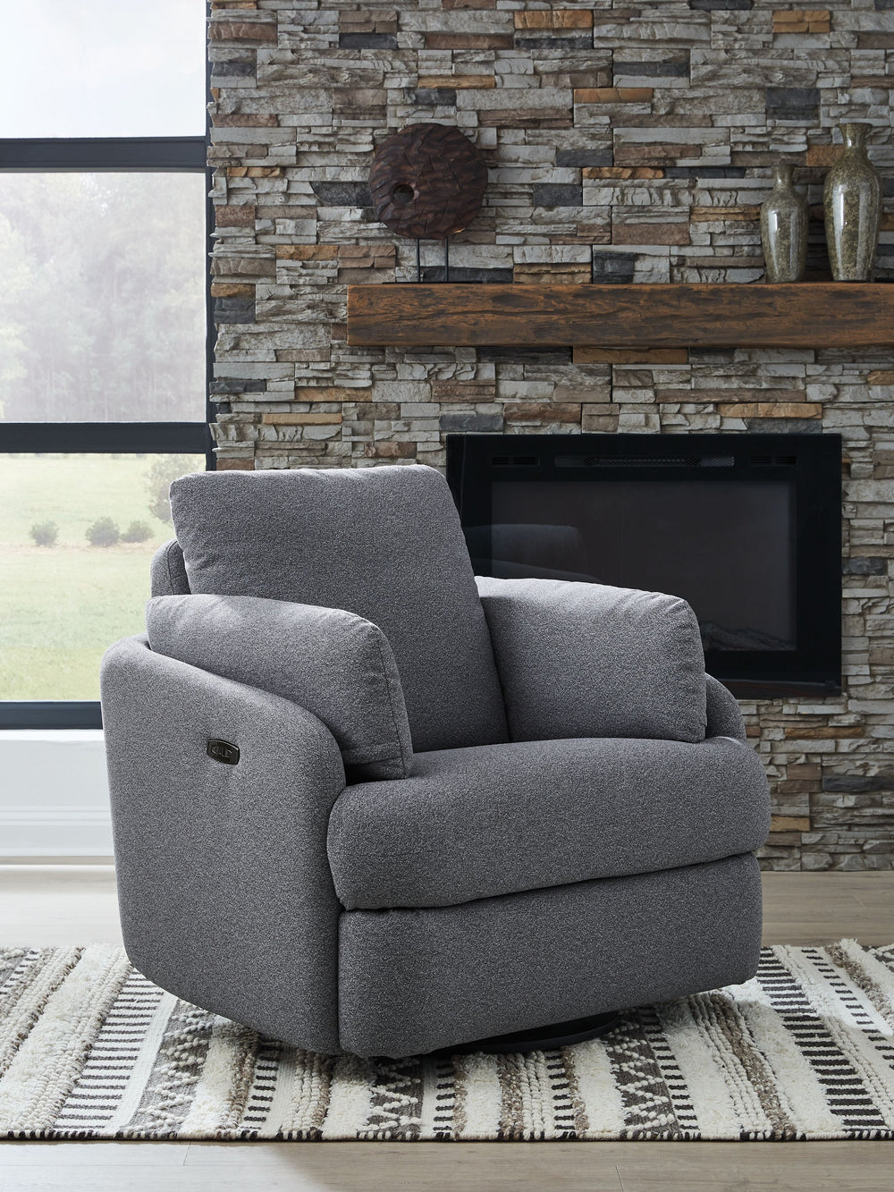 Indulge in ultimate comfort and style with this Next-Gen Nuvellaâ„¢ swivel power recliner. The contemporary chair allows you to effortlessly find the perfect position for relaxation, whether you-'re enjoying a movie night or simply unwinding after a long 