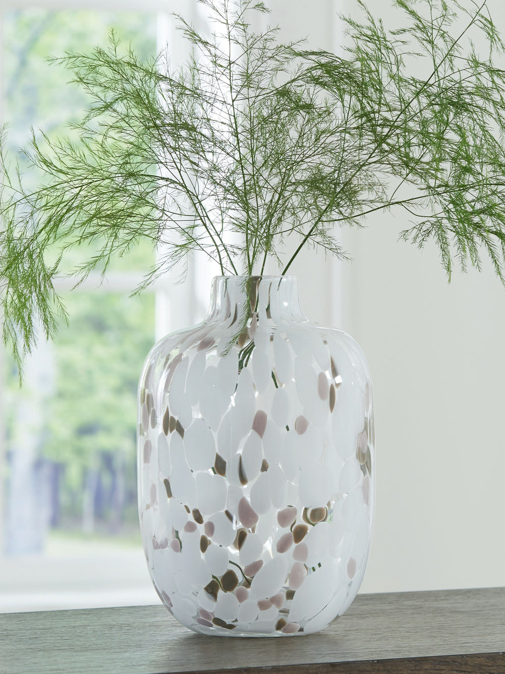 Be inspired by the artistry of blown glass. This beautifully crafted vase is a casual take on a classic silhouette, with versatile neutral hues that are right at home in settings from farmhouse to modern. Drop in the seasonâ€™s florals for on-trend appeal