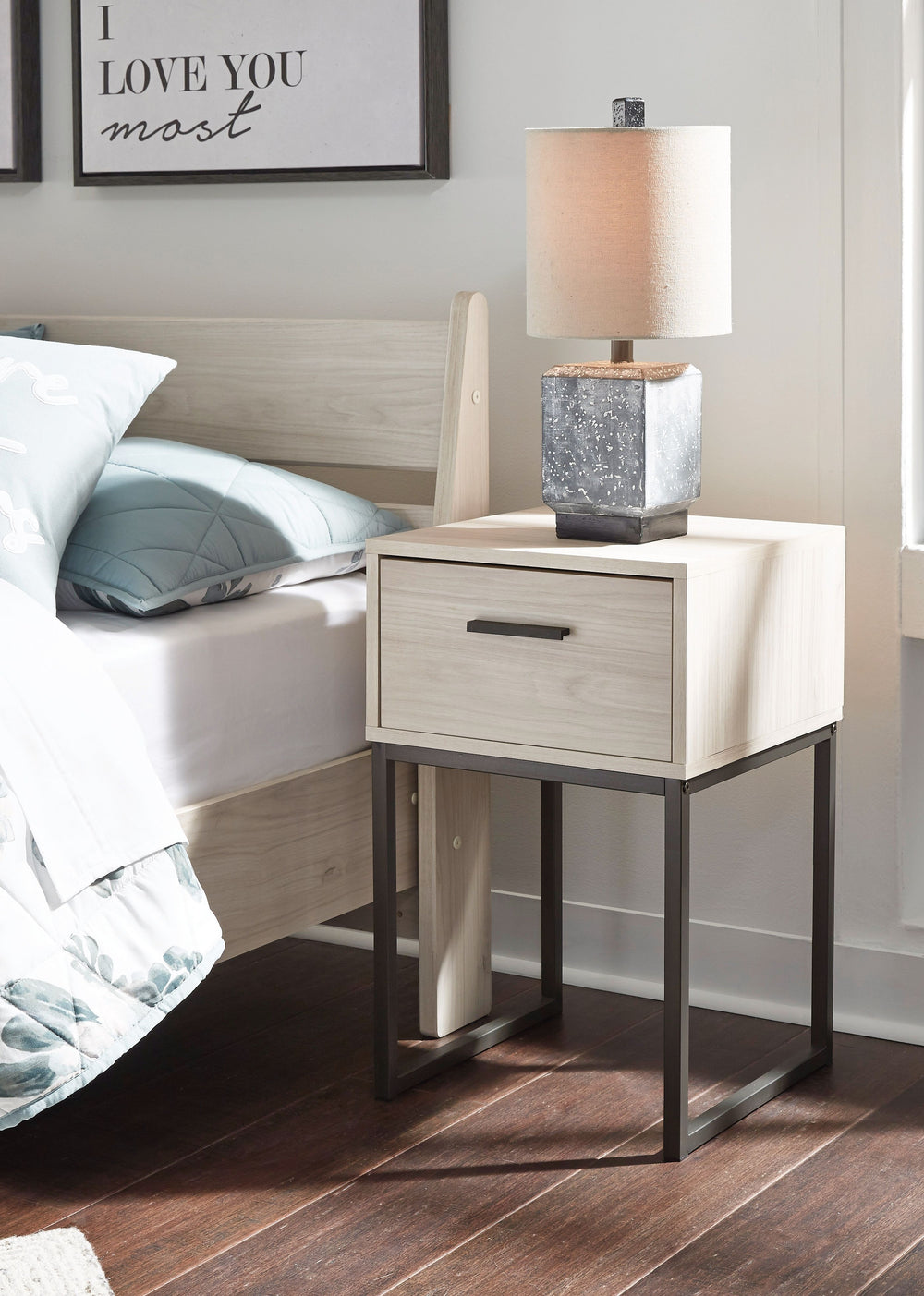 Light and bright, this nightstand is inspired by chic design. A light natural finish over replicated oak grain offers an authentic touch to this so-cool piece. It beautifully blends the hues of natural living with the edginess of your modern lifestyle.<br