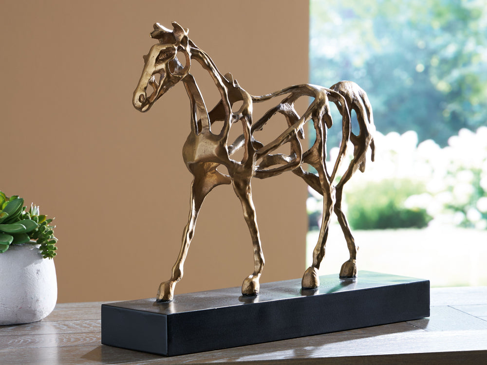 This magnificent equestrian sculpture is a stunning yet casual statement piece in step with your laid-back lifestyle. A cast iron figure in an antiqued goldtone stands atop a contrasting black metal base, making this sculpture a striking conversation star