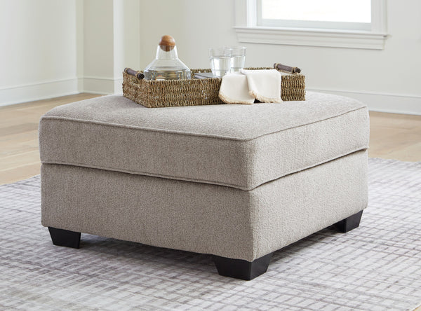  with concealed storage and cup holders beneath the removable cushioned top. With soft upholstery and a generous scale