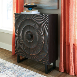  graced with a carved sunburst pattern and oversized wood pull