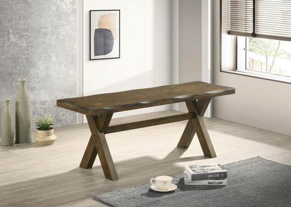  this dining bench embodies rustic charm with its knotty nutmeg finish and worn edges that highlight the natural beauty of wood. The sturdy trestle-style base provides reliable support