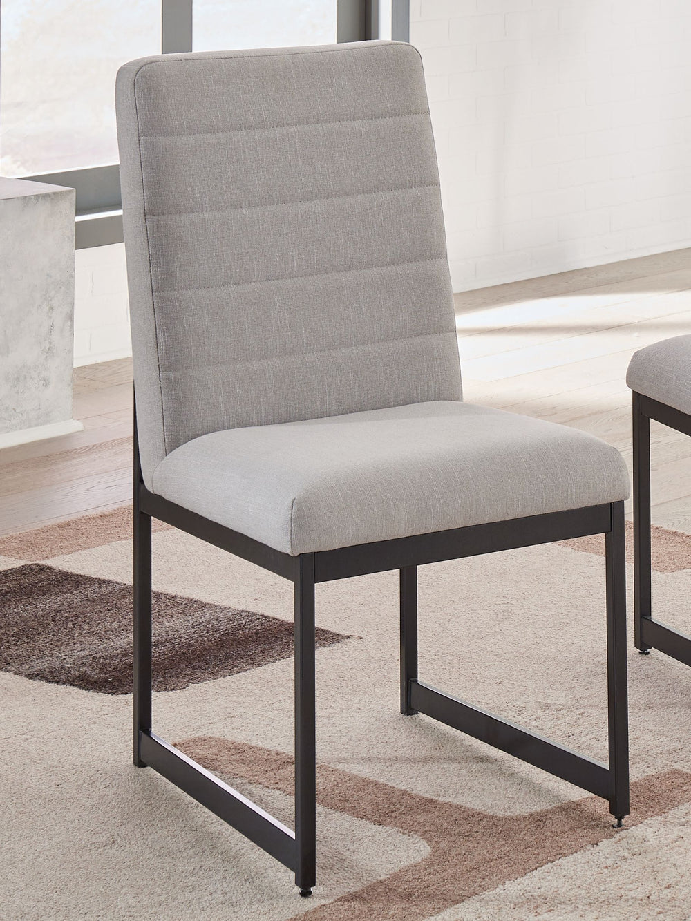 Sleek in its simplicity, this upholstered dining chair takes a relaxed approach to refinement. The mixed-material design brings a trendy urban-chic feel to dinner time. And with a cushioned seat upholstered in a light beige fabric, you stay comfortable as