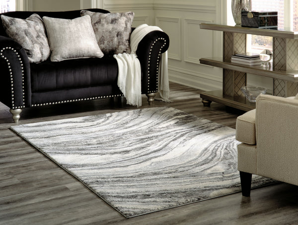  this area rug displays flowing ribbons of color. Its machine-woven high-low agate design