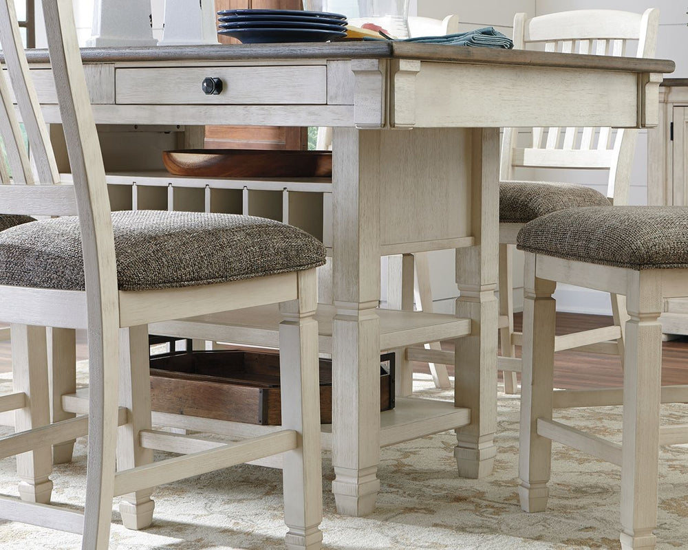 The beauty and practicality of this dining room counter table is something to savor. A two-tone textural finish gives this dining table with plank-effect top a double helping of charm. Four smooth-gliding drawers allow you to keep placemats, napkins and u
