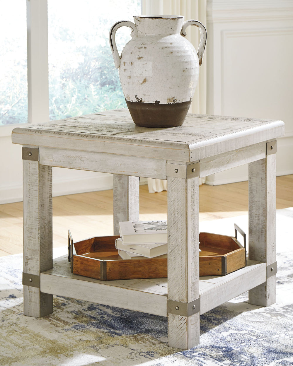 Add a quaint touch of farmhouse style to your living area with this end table. Its beautifully distressed light gray finish enhances the reclaimed wood-'s natural grain, which delivers a naturally aged feel straight from the countryside. You-'ll love its 