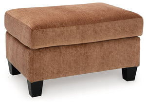 Urban contemporary meets mid century (with a pop of trend-right color) in this ottoman. Supremely soft upholstery, teeming with luster and movement, finesses the piece with just the right touch. Can you think of a better place to throw up your feet in she