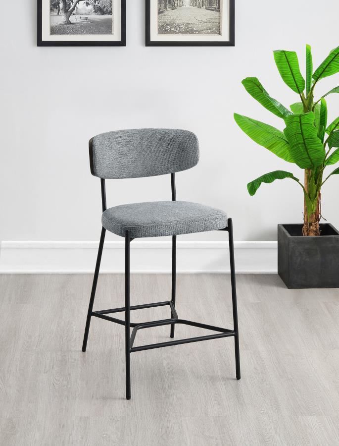 Introduce comfort and style with a set of two contemporary counter stools for your kitchen. Each features a black finish metal frame, offering streamlined character with slim structure and geometric details. Light, neutral upholstery covers foam cushions,