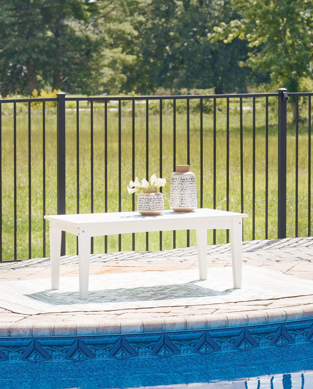 Drift into outdoor entertainment bliss with this coffee table. Dressed in a bright white for a fresh feel, it weathers sunny summer days and cozy winter nights with durable MEGA-TUFFÂ® HDPE material. When it comes to form and function, the table-'s rain-s