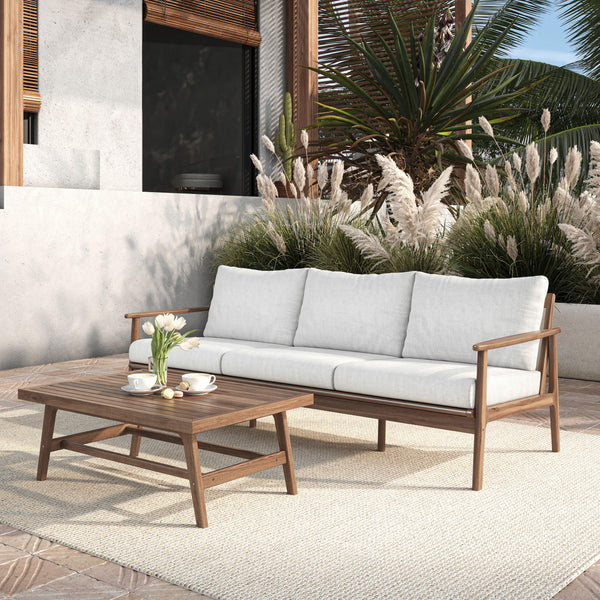  featuring a stylish outdoor sofa with natural cushions and a matching coffee table