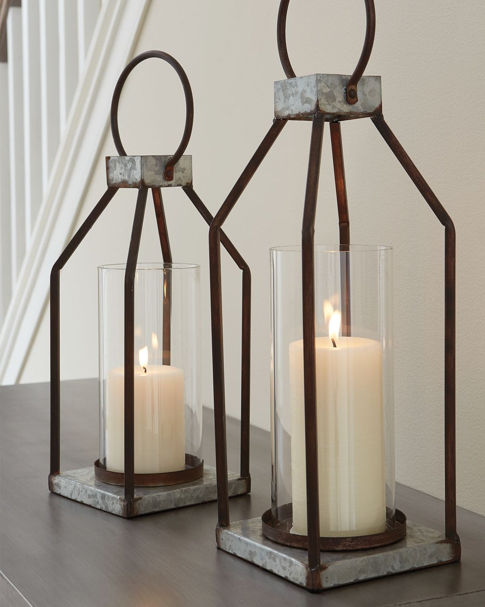 Whoever said you couldnâ€™t illuminate in style? This set of lanterns act as beautiful vessels for the romantic glow of pillar candles, whether placed in an indoor or outdoor space. The galvanized metal offers decor versatility, and the top metal handle a