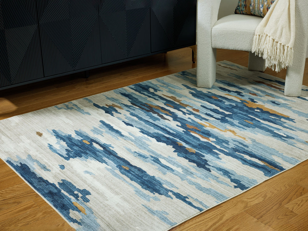 Add abstract flair to your floor with this rug. In a mixed palette of cool hues and muted neutrals, itâ€™s a subtly striking way to add contemporary color underfoot. Donâ€™t want to deal with upkeep? This rug is machine washable for easy care.<br/><br/><b