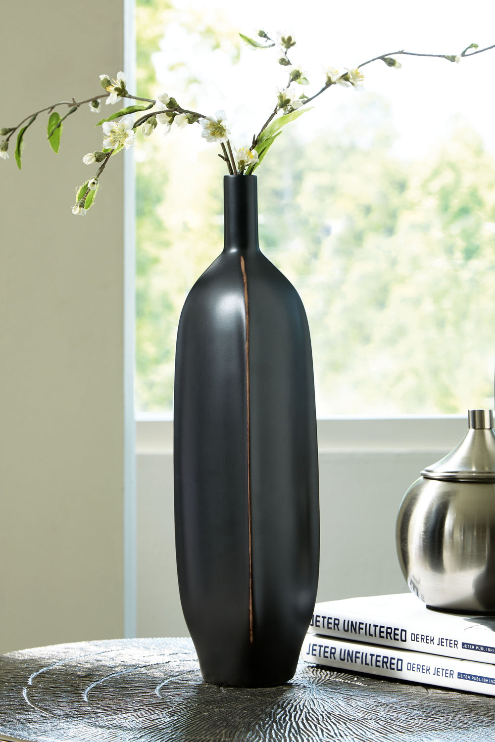 Impress with the simply sleek stylings of this vase. A black finish coats the piece, with a brown rub on the corners acting as a subtly eye-catching design element. What a chic addition to your bookcase, mantel or tabletop.<br/><br/><b>Product Features</b
